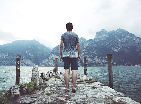 A man standing by a lake