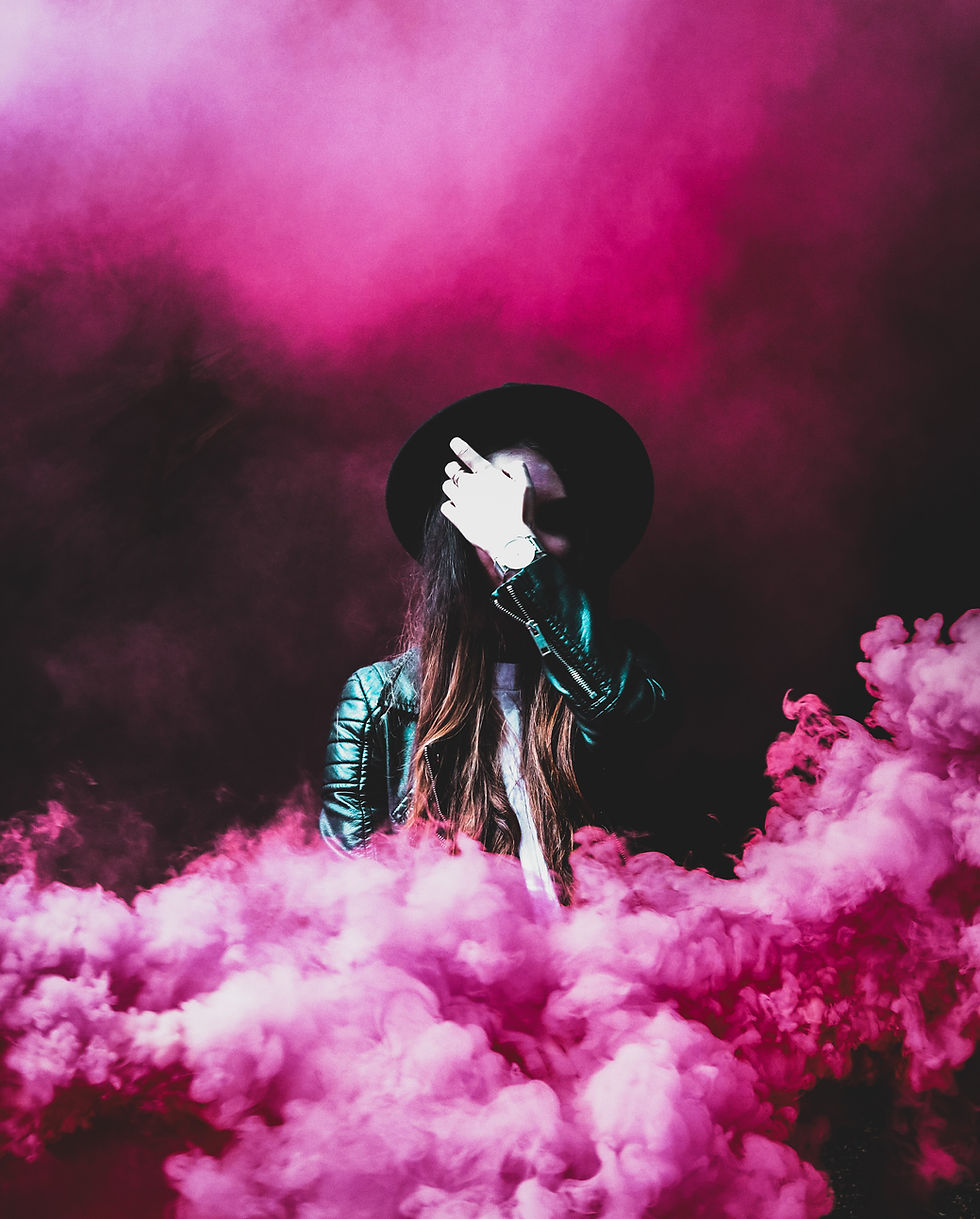 Woman with hat in a pinkish foggy set- Image by Joshua Fuller