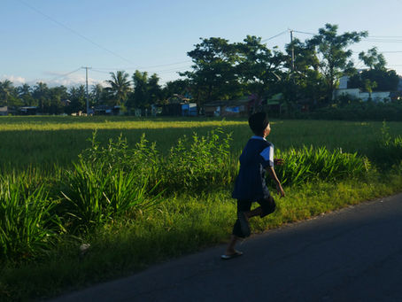 boy running on a road