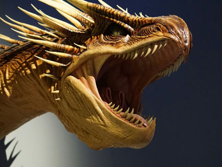 A roaring dragon emerges from ocean waves, its mouth wide open, spiked scales glistening under a dark sky, conveying power and drama.