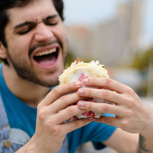 Hungry man eats a taco