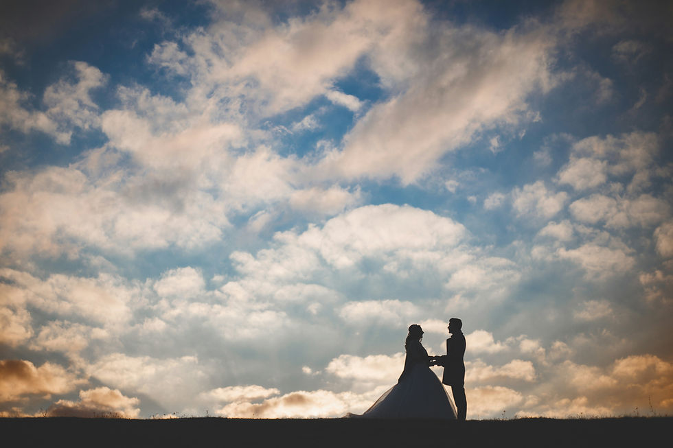 Against a breathtaking sunset, the bride and groom embrace as they step into their forever.