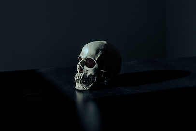 Person looking out a window at dusk, reflecting on fear of death.