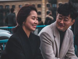 Asian couple talking outside