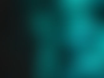 Close-up of a woman in glasses lit by teal LED lights, gazing thoughtfully in a dark, moody setting.