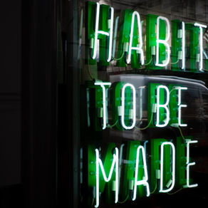 Neon sign saying Habits to be made