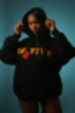 Female wearing black hoodie with "Survivor" written in orange
