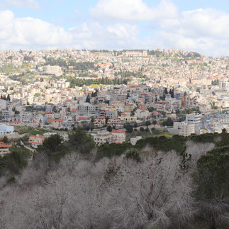 Wide panoramic view of the hillside city of Nazareth and the rolling landscape of the Lower Galilee.