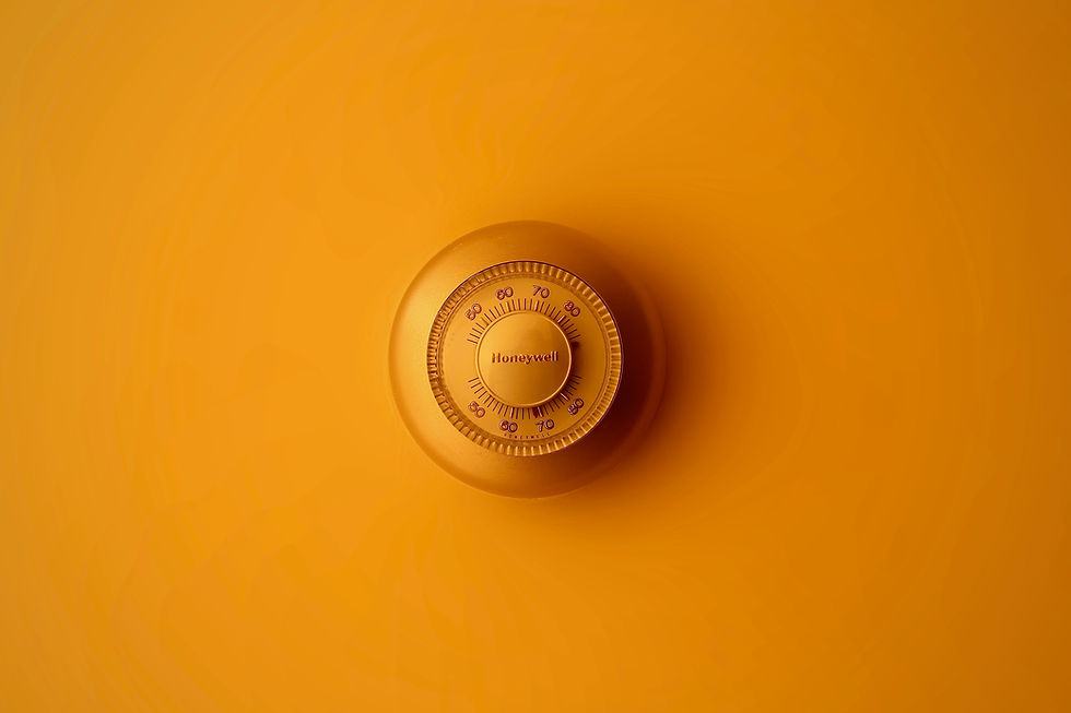 Thermostat on a yellow wall
