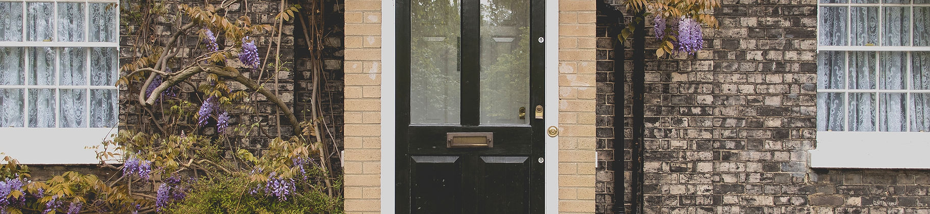 A welcoming front door of a well-maintained home, symbolizing protection and security with property insurance.
