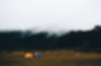 Image of a few tents in the open front range.