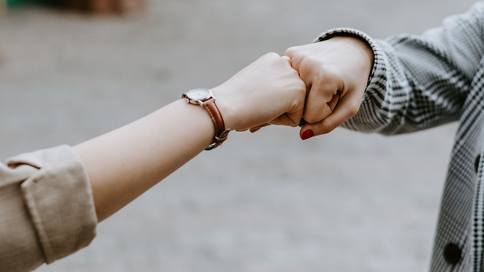 Friends fist bumping