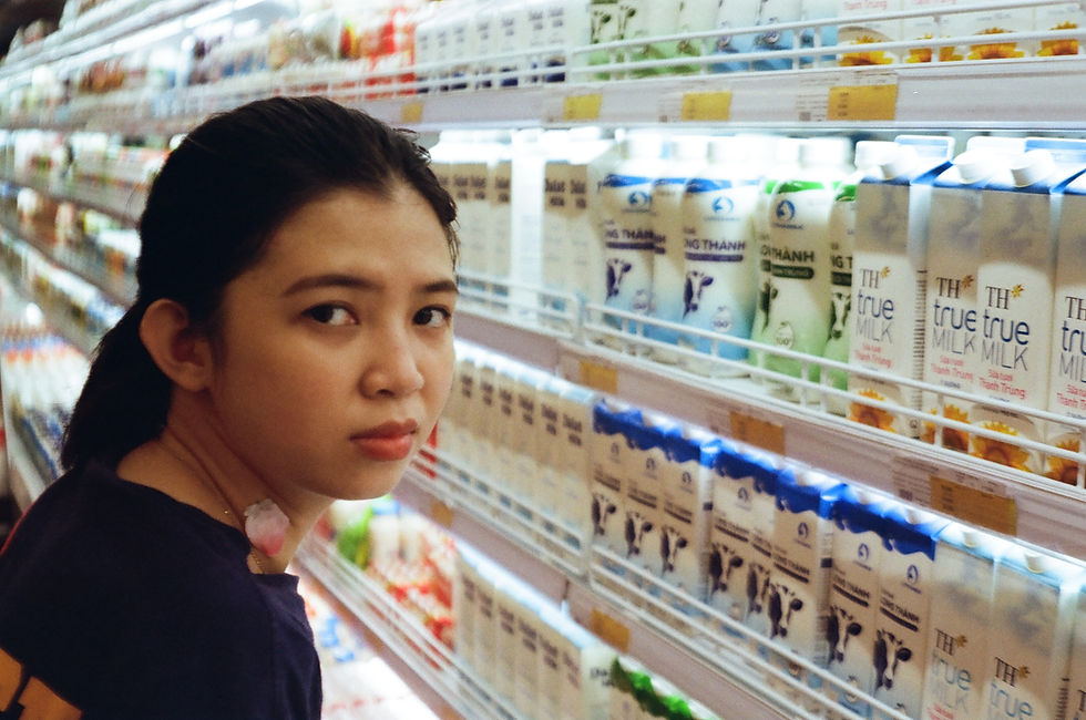 supermarket shelves displaying many different types of milk