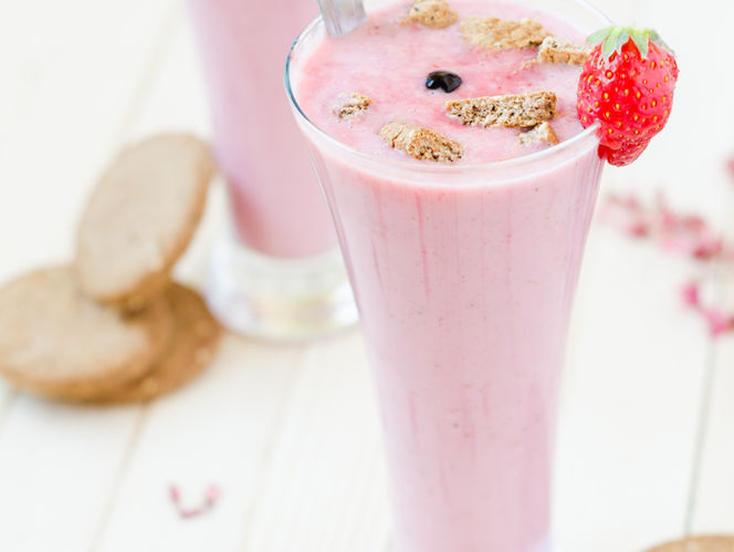 pink smoothies on a table with sliced bread