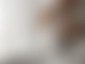 Frau in weissem Gewand beim Meditieren. Man sieht den Kopf nicht aber eine Hand auf dem Herz, eine auf dem Bauch.