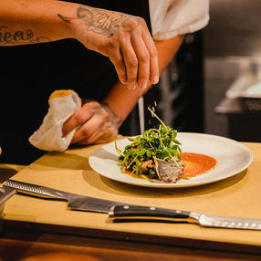 chef seasoning a plate