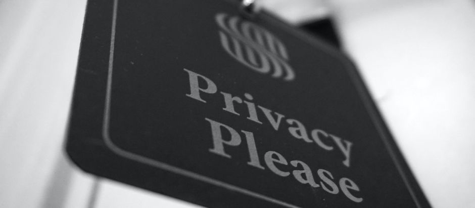 Privacy tag hung on hotel room door reminds us of our basic human need for privacy.