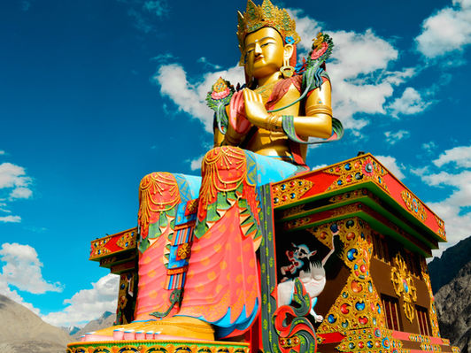 Giant Buddha statue at Diskit Monastery against a clear blue Ladakh sky — Global Journeys