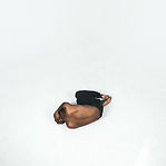 Person curled up in a ball on light gray floor