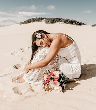 bride seating by the sand