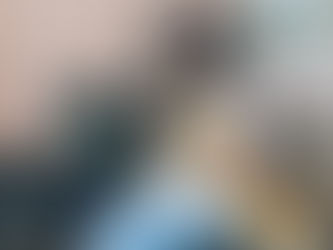 woman holding a coffee cup while her dog lies across her lap