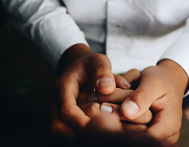 Doctor holding a patients hand, dark skinned hand