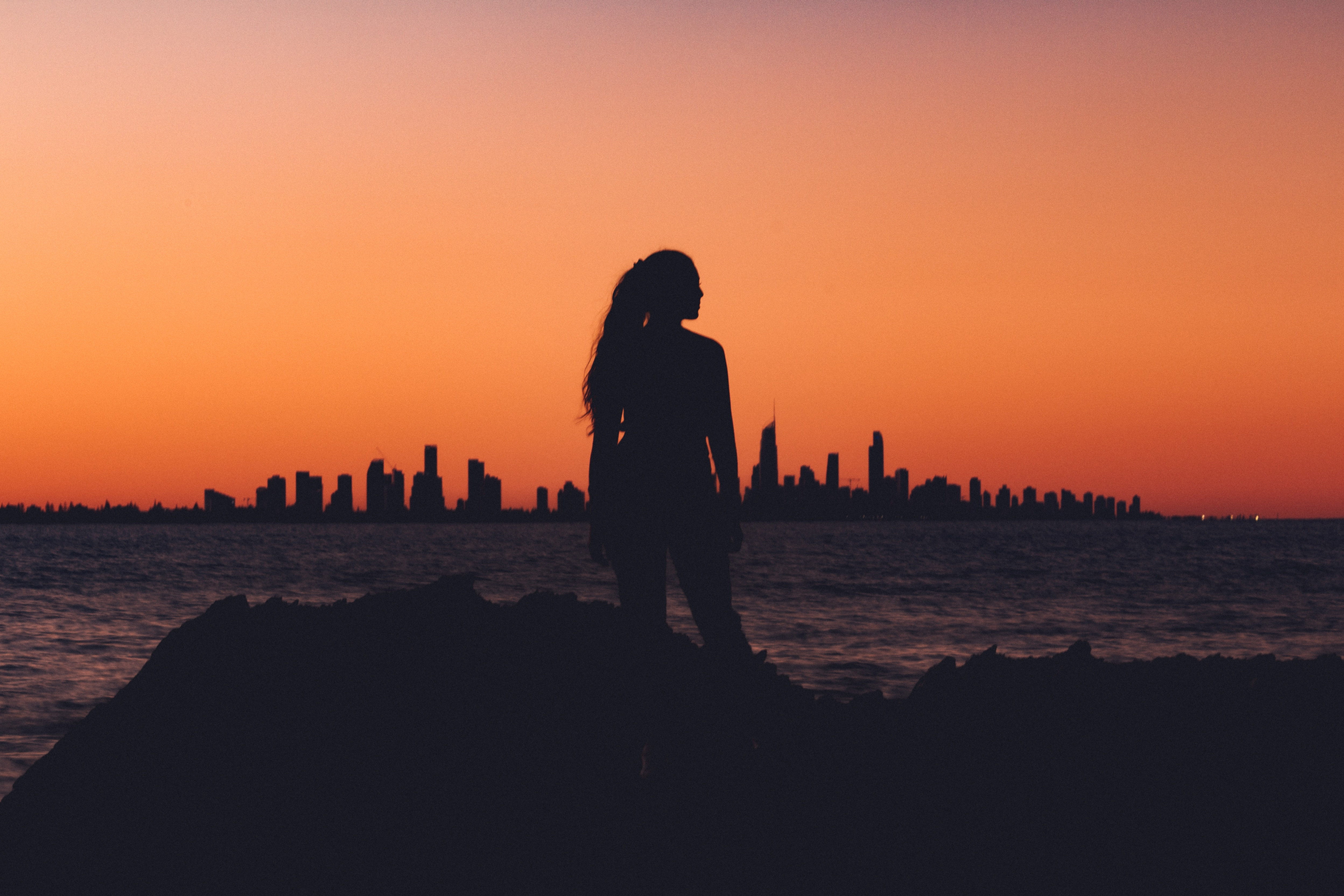 Woman standing confidentlt at sunset