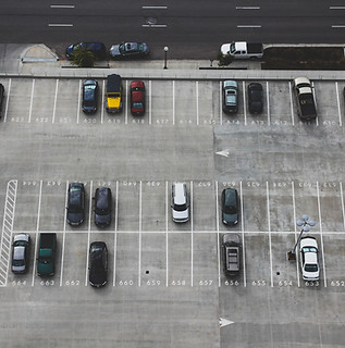 Aerial view of car park, half full of cars. Image by John Matychuk.