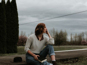 A middle aged women looking into the distance on a cloudy day