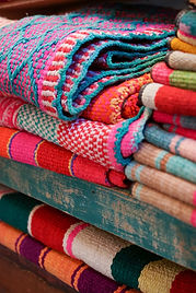 Stacked knitted garments in bold colours