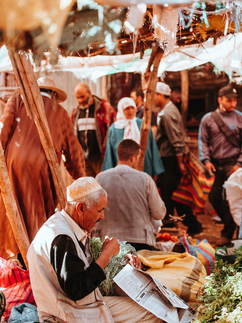 Local market scene in Mirleft, Morocco, with traditional crafts and daily life