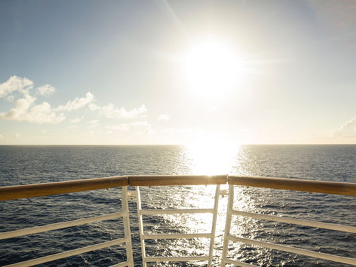 golden hour horizon off the bow of a cruise ship