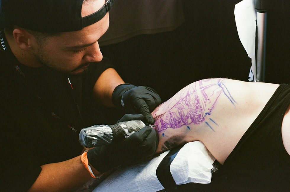 Man tattooing a design