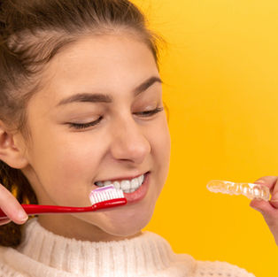 young girl with toothbrush and braces
