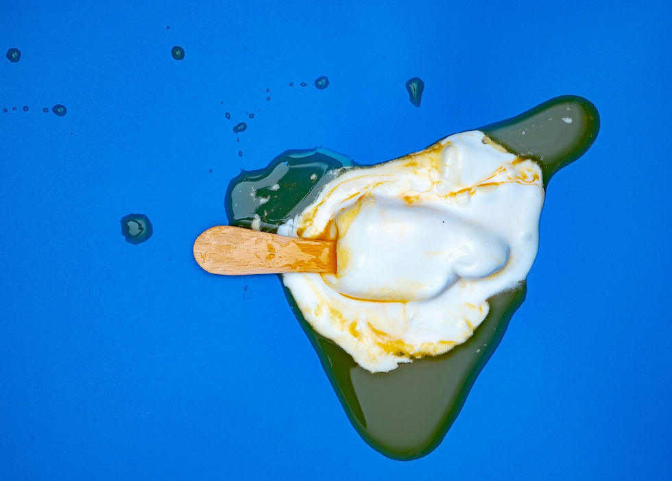 Melted Ice Cream bar splattered on a blue background
