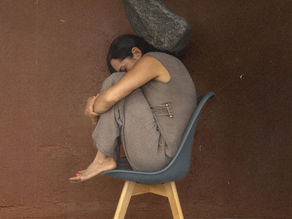 A woman alone, overwhelmed from the mental load.