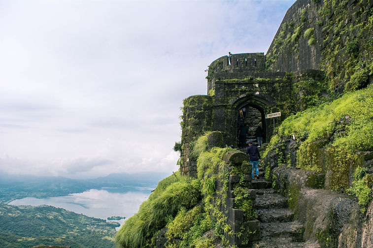 a stone staircase on a cliff lohagad fort