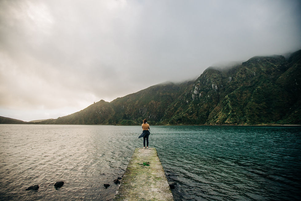 Women solo travel looking across lake