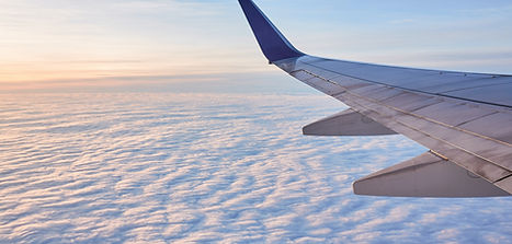 Airplane wing flying above the clouds