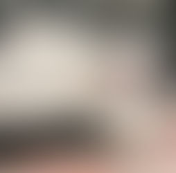 white cat with black spots - lying contemplatively on one side