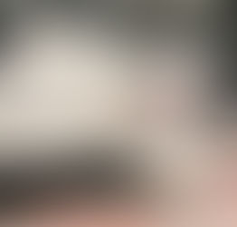 white cat with black spots - lying contemplatively on one side