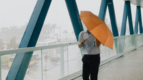a man going to work during typhoon days