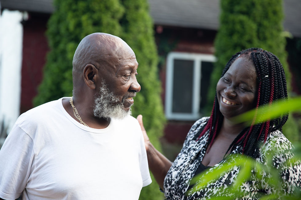 A cancer survivor who finished his treatments is looking at his caregiver.