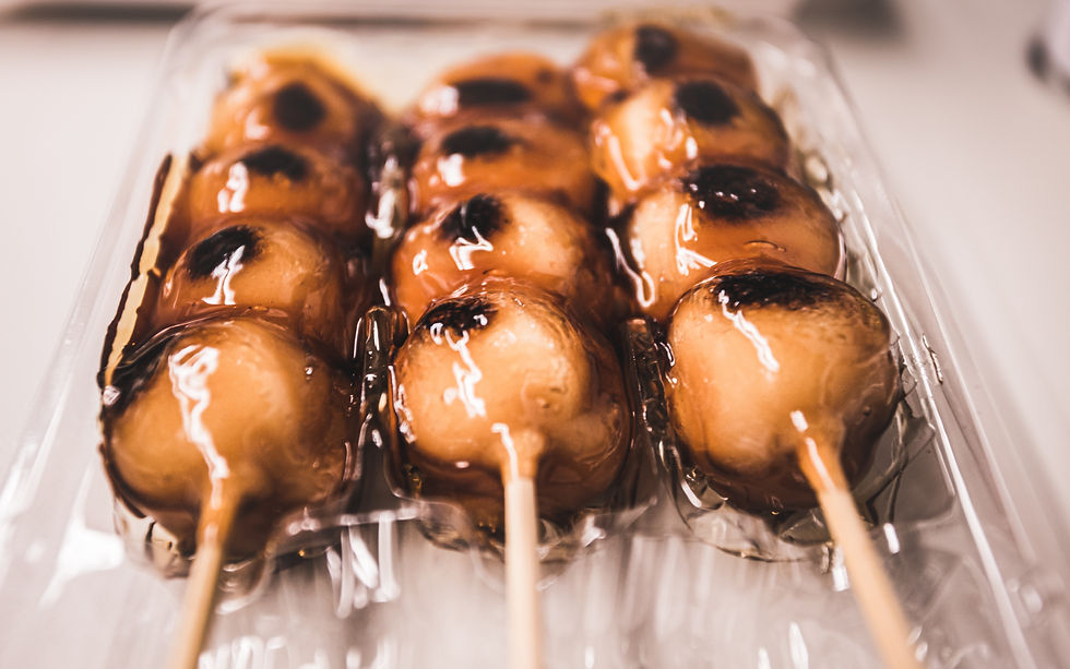 Three sticks of sweet soy sauce glazed mitarashi dango.