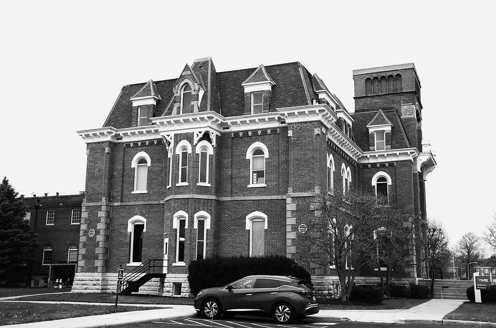 A personal injury attorney in Richmond, Kentucky, discusses a case with a client while reviewing legal documents in a professional office setting.