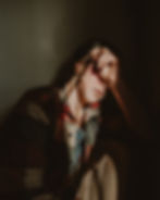 Image of a woman looking worried and sad.
