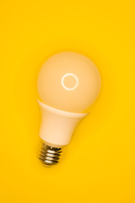 Lightbulb on a bright yellow background.