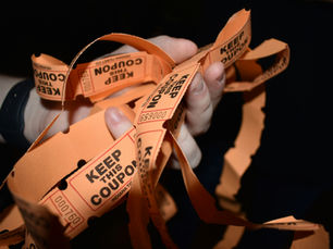 A hand holding lts of coupons