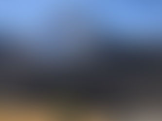 Woman looking up at mountain peak