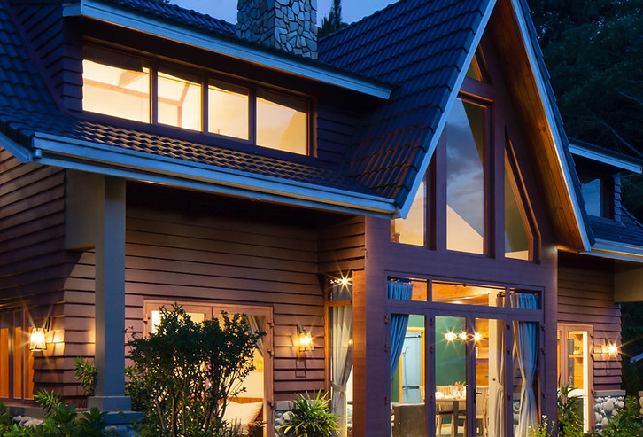 New Home in the Woods Lit Up at Night